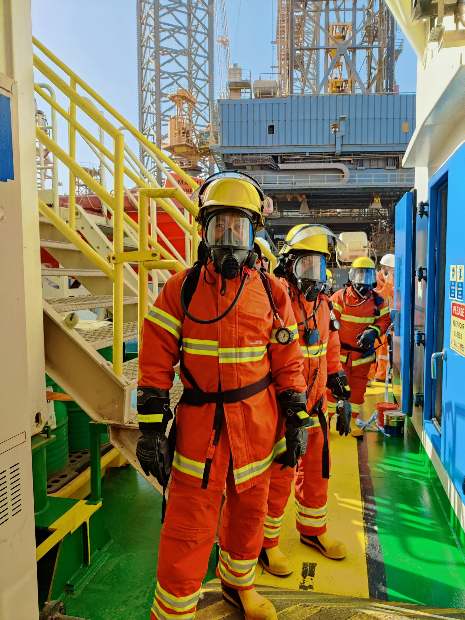 Firefighters wearing gas masks and gear at Ras Laffan industrial facility, Qatar.